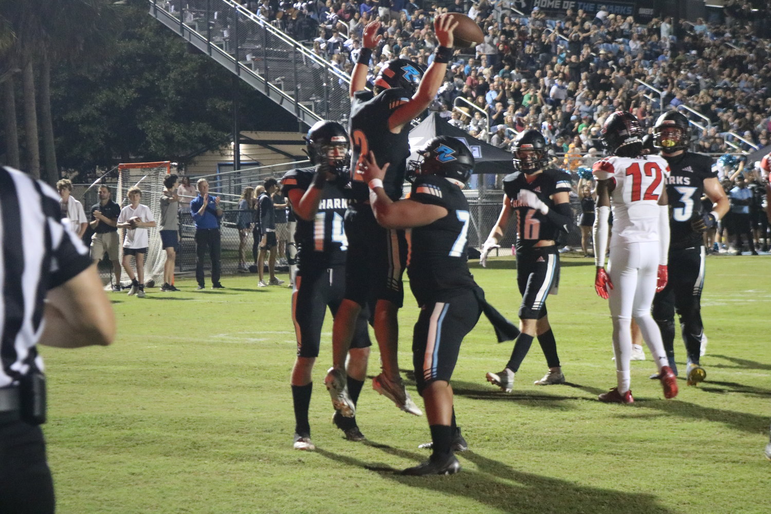 Ben Burk (No. 12) leaps into the air to celebrate a touchdown.